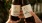 a couple of hands holding bottles of alcohol