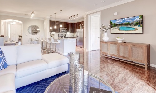 a living room with a large glass table and a couch