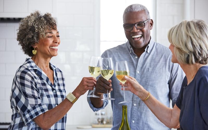 a few people toasting wine glasses