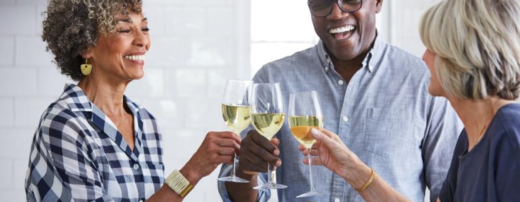 a few people toasting wine glasses