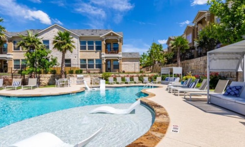 a swimming pool in front of a building