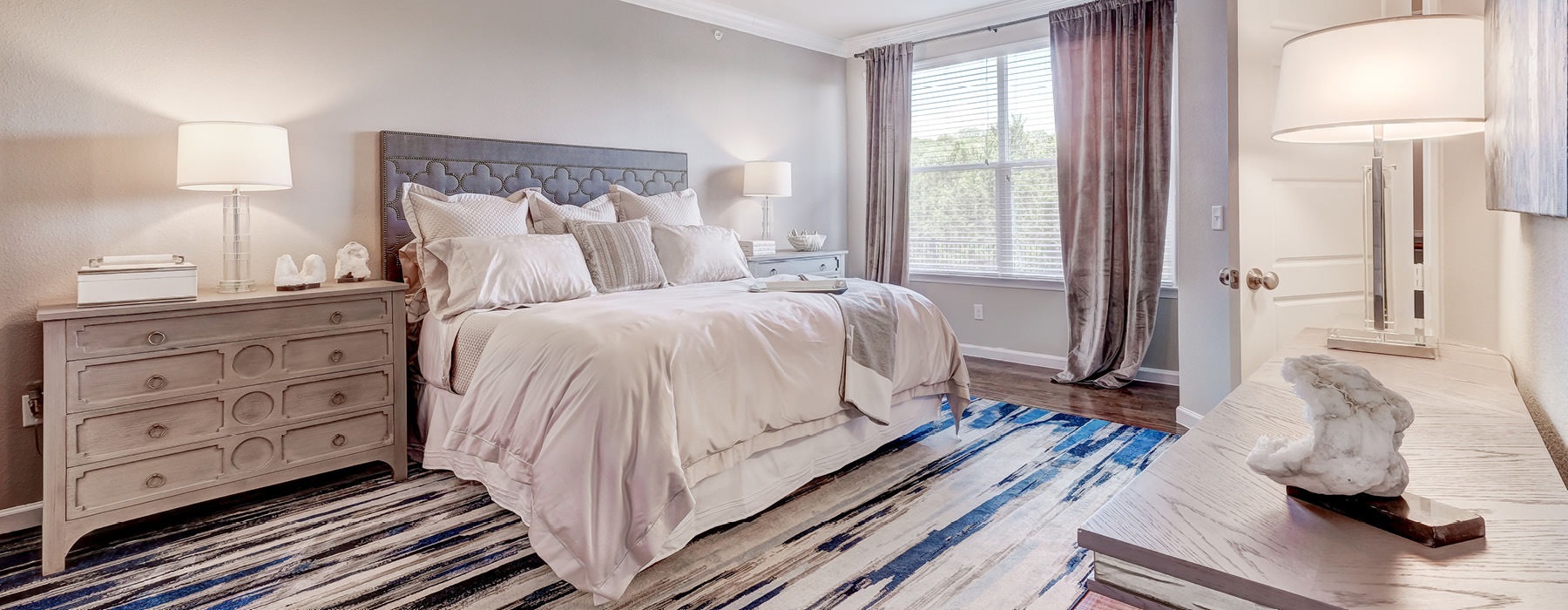 a bedroom with a bed and a fan