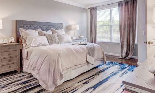 a bedroom with a bed and a fan