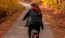 a person riding a bicycle on a path in the woods